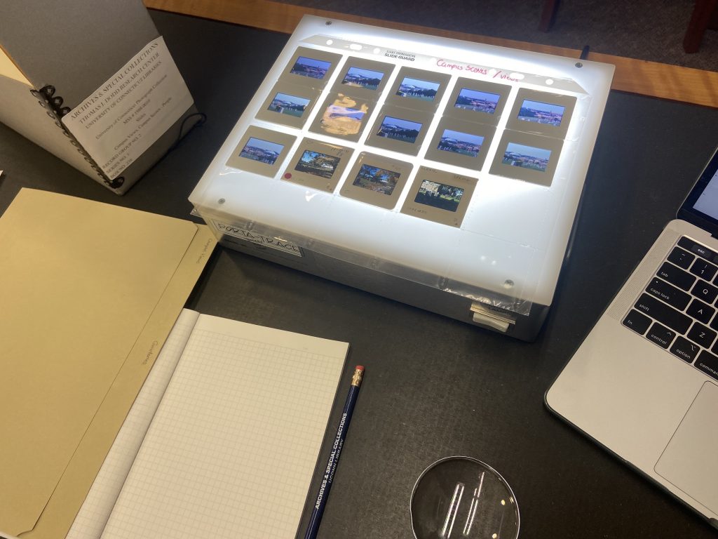 Jess’s notebook and laptop on a table at the Dodd Center archives