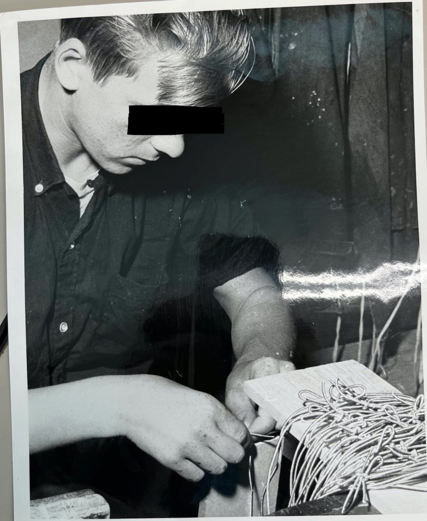 Resident assembling a coil for an unknown machine